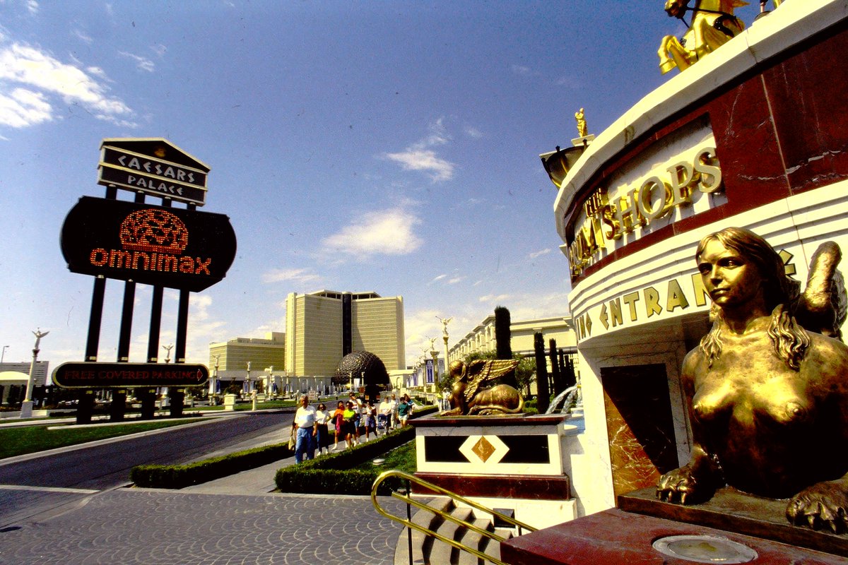 las_when's tweet photo. Caesars Palace, The Forum Shops, The Omnimax. Marquee advertising "Free Covered Parking." Does free parking return, or prices get reduced, with new ownership? https://t.co/9WQx9BaIV3