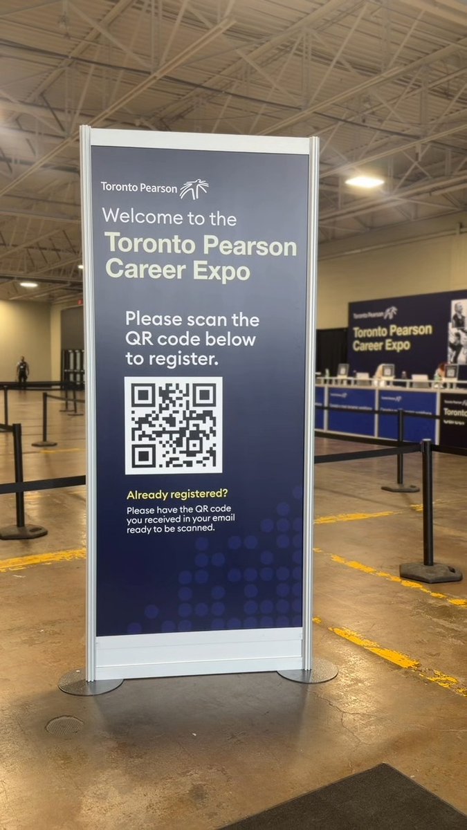 A sign inside a venue reads "Welcome to the Toronto Pearson Career Expo" and instructs attendees to "Please scan the QR code below to register," with another sign visible in the background.