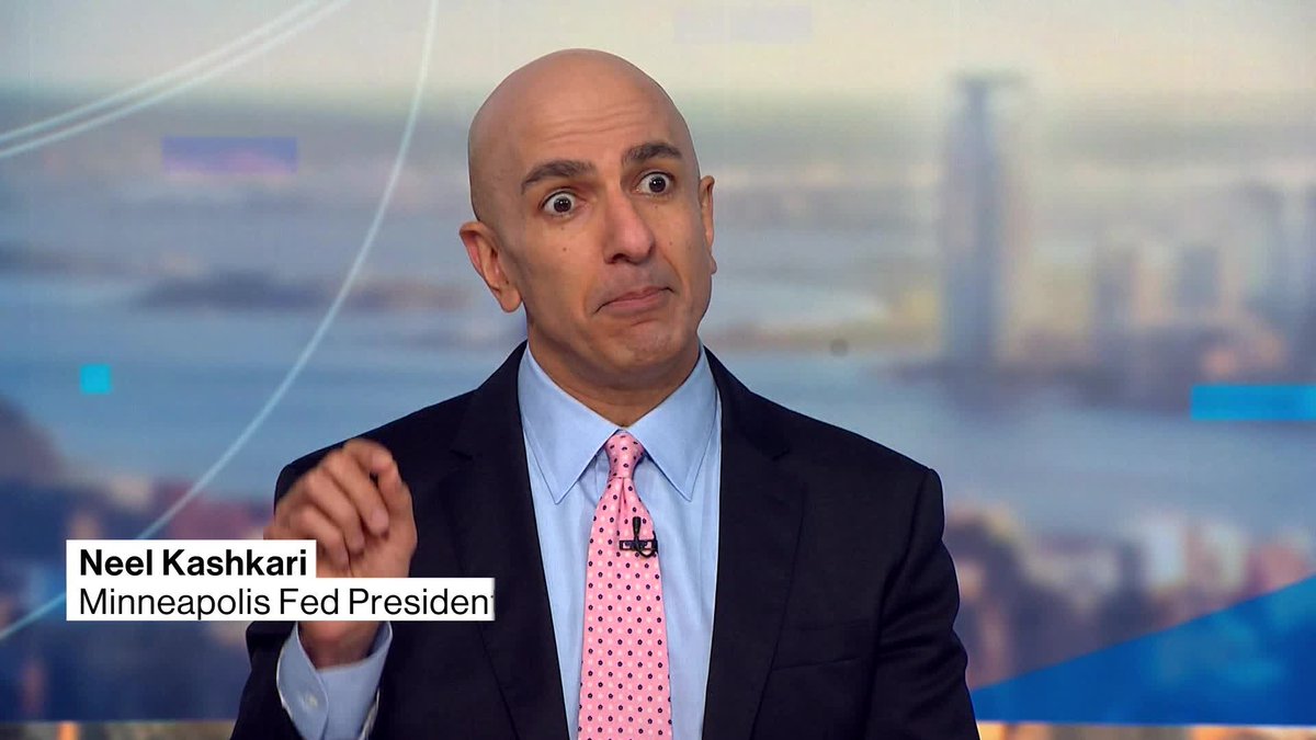 Neel Kashkari, Minneapolis Fed President, appears on a Bloomberg TV interview with a city skyline backdrop, his expression conveying concern as he likely discusses the Federal Reserve's response to surging Treasury yields following the 10-year's climb to a 24-year high.