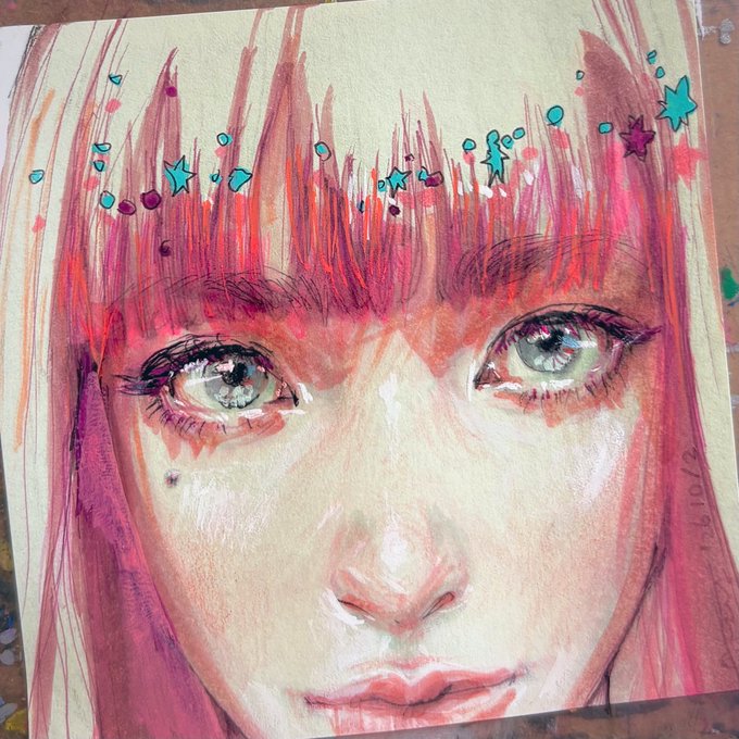A vibrant mixed-media painting of a girl's face with striking green eyes and pink hair, decorated with hand-drawn teal stars and dots across the forehead area, dated 16/10/2.