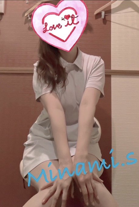 A person in a white outfit sitting on a chair with their face covered by a 'Love it' heart sticker, with 'minami.s' watermark in blue text.