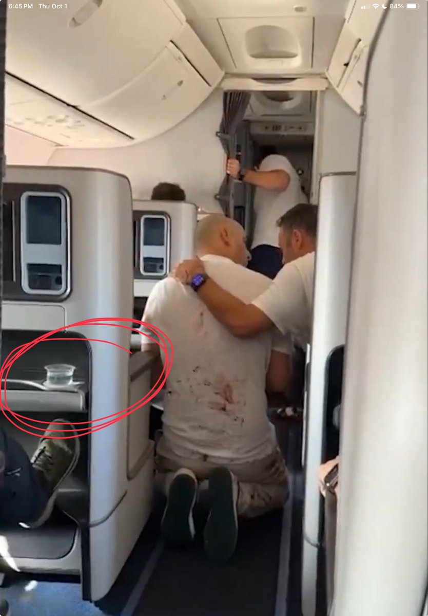 Ashley__USA's tweet photo. @TheLongInvest Would there still be a full cup of water sitting here? Or… is it typical that the stewardess would be handing out refreshments while men struggle to hold a terrorist feet away within minutes of a nosedive? https://t.co/O8SvrLSYH1