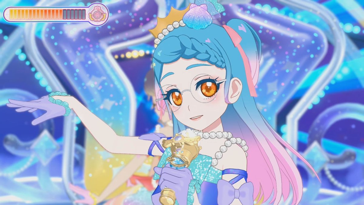 An anime-style character featuring a blue-haired girl with orange eyes wearing glasses, a crown, pearl necklace, and purple gloves, holding a wand against a sparkly starry background with a power meter at the top.