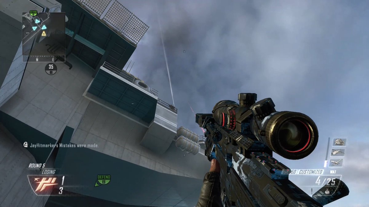 A first-person view in a Call of Duty game shows a player holding a customized sniper rifle (USR-50) while looking up at an industrial structure, with the HUD indicating they're "LOSING" Round 5 and need to "DEFEND B." The chat message "Mistakes were made." by JayHitmarkers hints at the high-skill sniper gameplay and trick shot attempts typical of a trickshotter's gaming session.