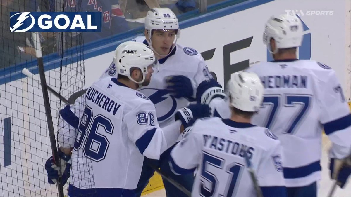 Tampa Bay Lightning players, including Nikita Kucherov (#86) and Victor Hedman (#77), celebrate a goal with a "GOAL" graphic displayed on the broadcast after Kucherov cut into the opposing team's lead.