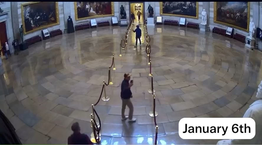 Security camera footage from the U.S. Capitol Rotunda, with a white box overlay reading 'January 6th' in the corner, showing a person standing alone in the large hall.