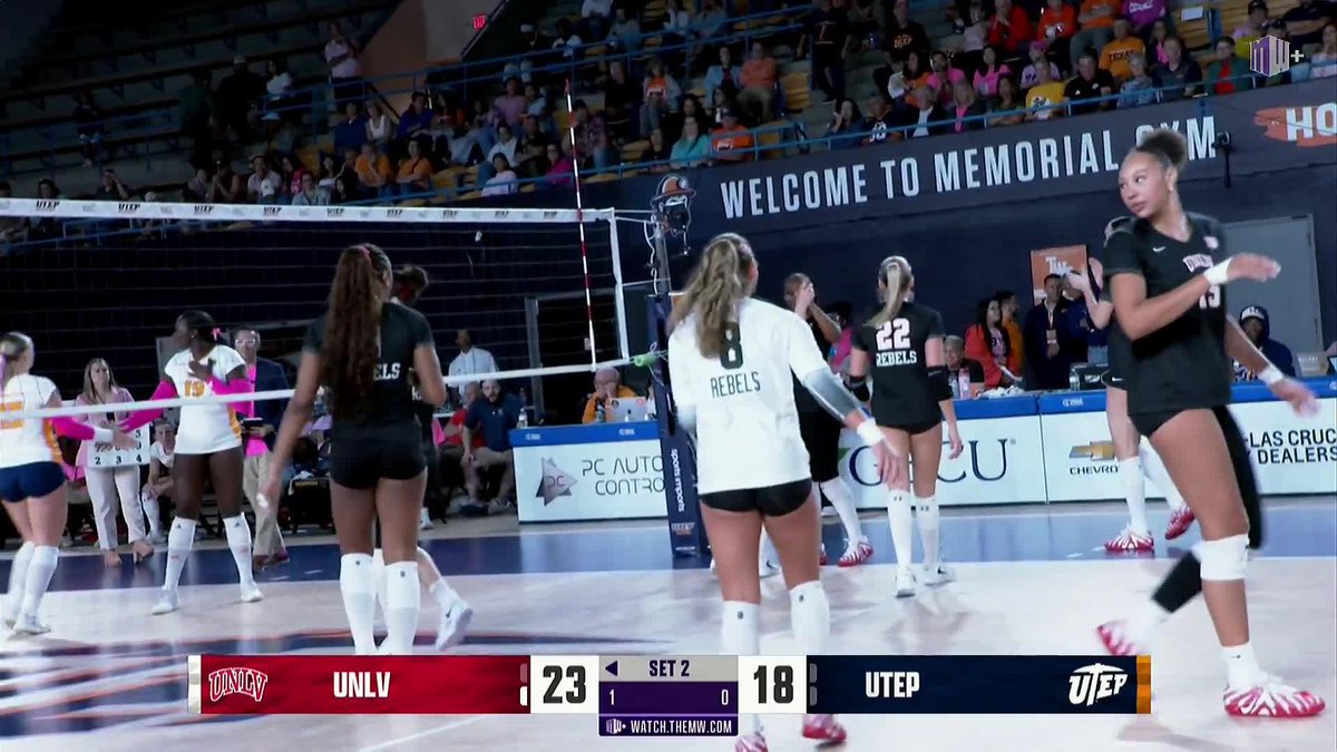 A volleyball match at Memorial Gym between UNLV and UTEP during Set 2, with UNLV leading 23-18, showing Rebels players on the court with 'PC AUTO GROUP' and 'Las Cruces Dealers' sponsor signage visible.