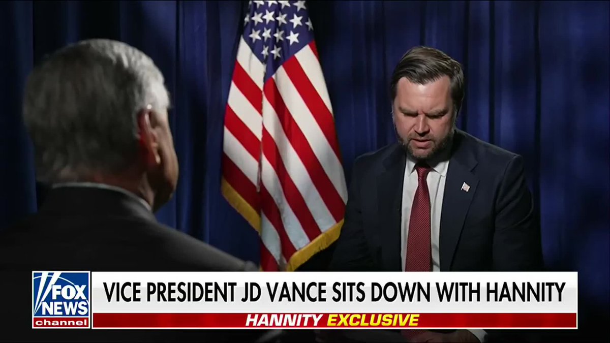 A Fox News broadcast titled 'VICE PRESIDENT JD VANCE SITS DOWN WITH HANNITY' with 'HANNITY EXCLUSIVE' banner, showing JD Vance in a dark suit and red tie sitting across from interviewer Sean Hannity with an American flag in the background.