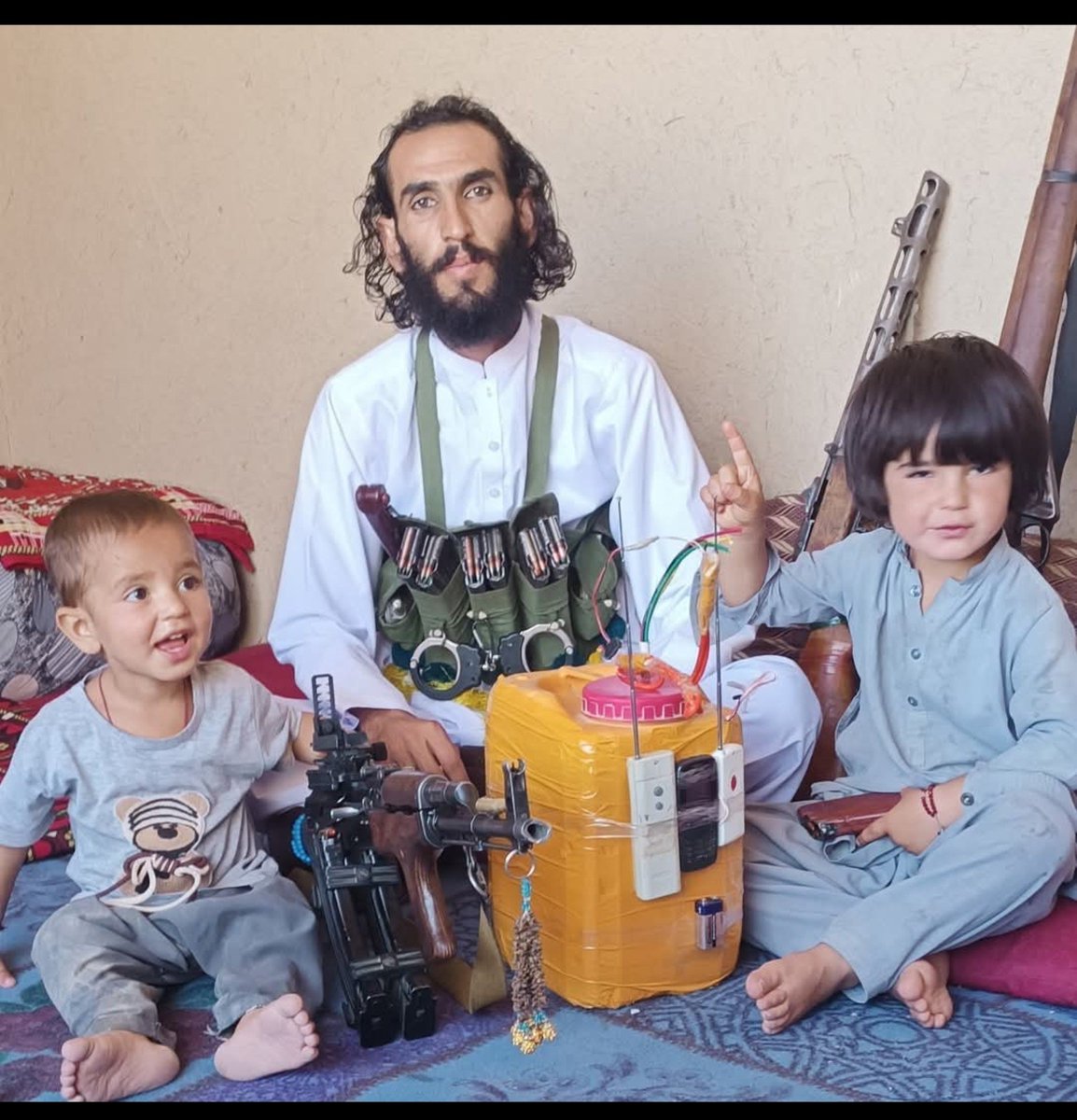 ForumStrategic's tweet photo. An afghan terrorist from logar, afghanistan prepares a remotely operated IED, weapons & ammunition is visible in the picture, also his innocent 2x sons.

Now the question is if Pakistan strikes this terrorist preparing IED to kill Pakistanis, will that be considered as "civilian casualties"?

The reality is that afghan terrorists intentionally live near or inside populated areas to avoid airstrikes, however such tactics won't work anymore.

Passing hatred against Islamic Republic of Pakistan hasn't worked & won't work well for the afghans.