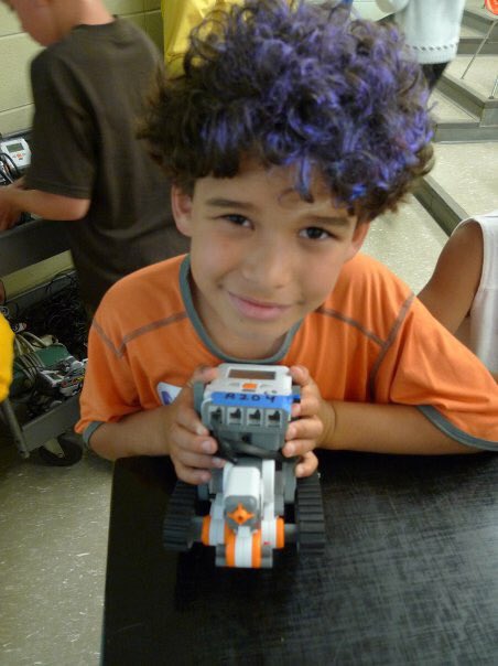 MalJMacDonald's tweet photo. This is me from ~15 years ago.

What do you think is making this kid smile? Maybe it’s because his team won 1st place, or because he’s technically playing with Legos, or even just because mom asked politely.

All those are probably true - but I believe now there was a deeper reason for that grin, a reason younger me felt but didn’t know.

He’s building.

Building things, especially with technology, has always been what I enjoy. Over the years it might have slowed, but it never stopped.

Well, over the last 2+ years I’ve been building a LOT more - and I wanted to use this as a reintroduction of myself and to share about what I’ve been doing and what’s to come.

Understand these few things:

I am not trying to become some sort of influencer or talking head online - lord knows we don’t need more of those

This is for ME. I hope what I share helps you think more and inspires you to build more (I’m confident it will) - but I’m not doing this for anyone else but the betterment of myself and my goals.

All of what I plan to share about has been done in the early mornings, late nights, and weekends that can’t ever be long enough.

So,

If you’ve stayed to read this long, you might be wondering what I plan to share about.

Lumintel - I started this business 18 months ago. Building it has taught me so much about helping people put AI to work in their businesses.

Things I’m building - Projects, experiments, what works, and what doesn’t. There is no good reason I can’t share what I learn along the way.

Thoughts and essays - In the age of AI it becomes extremely easy to outsource our thinking to AI. I want to fight that atrophy for myself by thinking harder and deeper than I ever have before.

And of course much more!

P.S. should I grow out the Afro like young Malcolm had??