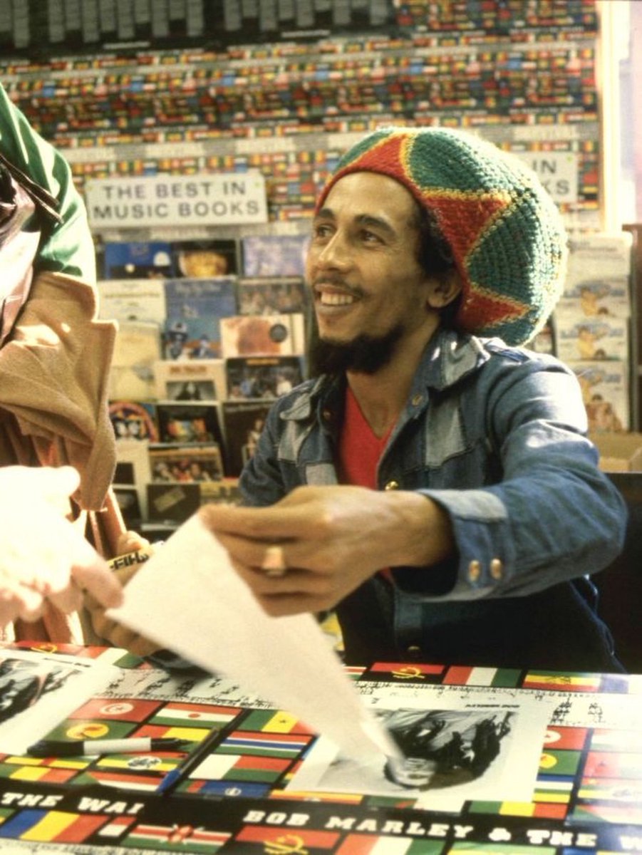 CloutedWear's tweet photo. Bob Marley signing copies of "Survival" at Tower Records in West Hollywood, photographed by Chris Walter (1979) https://t.co/o90n7Haojw