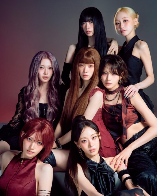 A group photo of the K-pop group aespa featuring members Karina, Giselle, Winter, and NingNing posing together in dark and red outfits against a dark background.