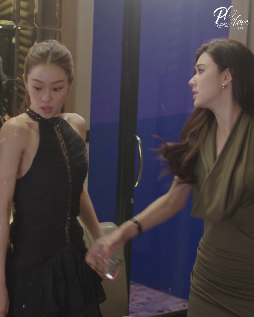 A scene from 'We Love EP4' showing two women in elegant dresses—one in a black halter gown and another in an olive green draped dress—near a blue door.