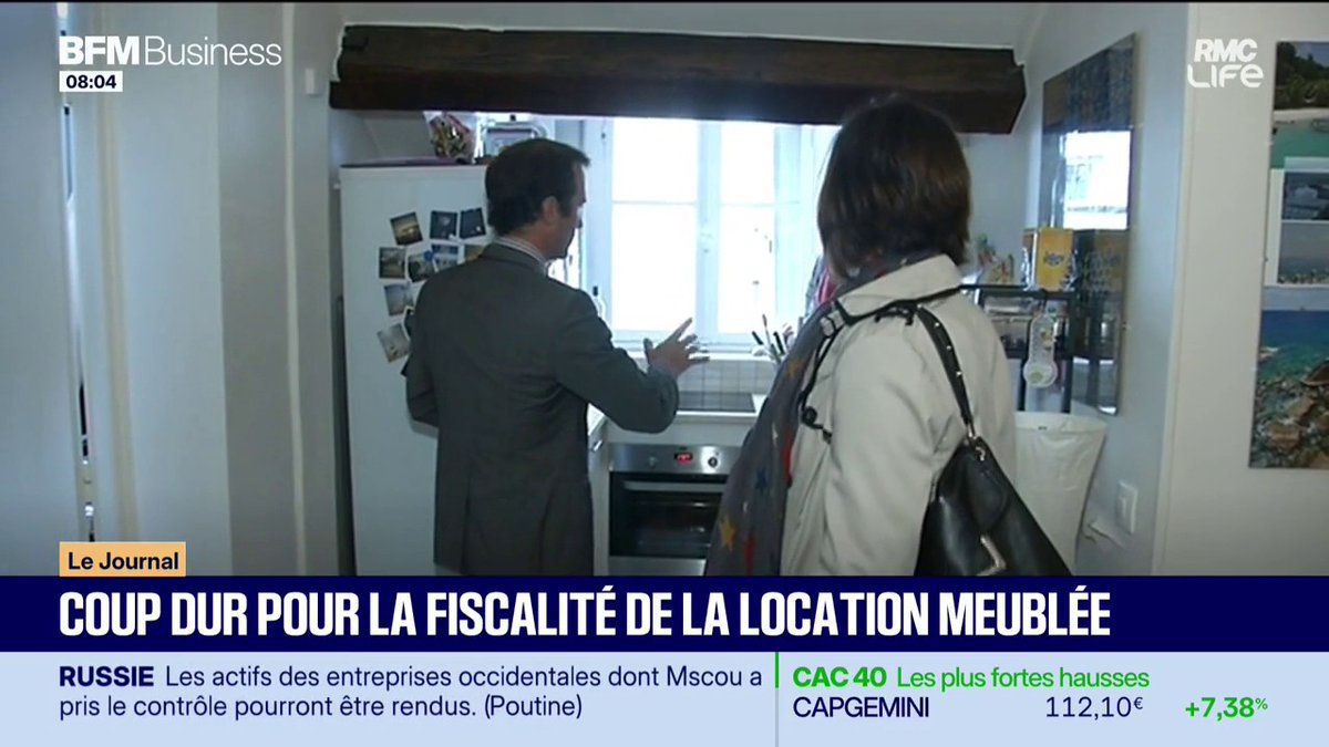 A man in a suit and a woman with a handbag stand in a kitchen during a BFM Business segment on furnished rental taxation. The on-screen headline reads "COUP DUR POUR LA FISCALITÉ DE LA LOCATION MEUBLÉE," with the CAC 40 ticker showing Capgemini up 7.38% at 112.10€ at 8:04.