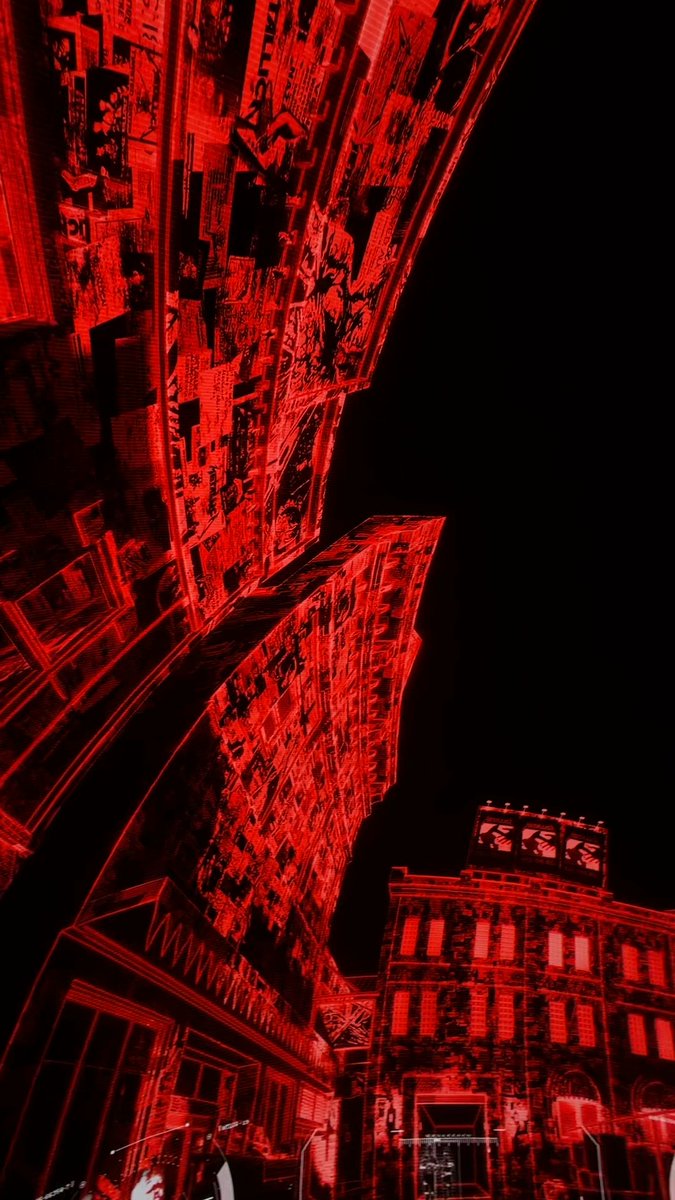 A stylized, red-and-black digital art piece depicts a towering cityscape rendered in glitch-like textures, with metallic building facades and a partially visible "www." web address wrapping around a storefront. The dystopian aesthetic amplifies the post's "SIGNAL INTERCEPTION" theme, fittingly paired with @metallica to evoke themes of technological chaos and resistance.