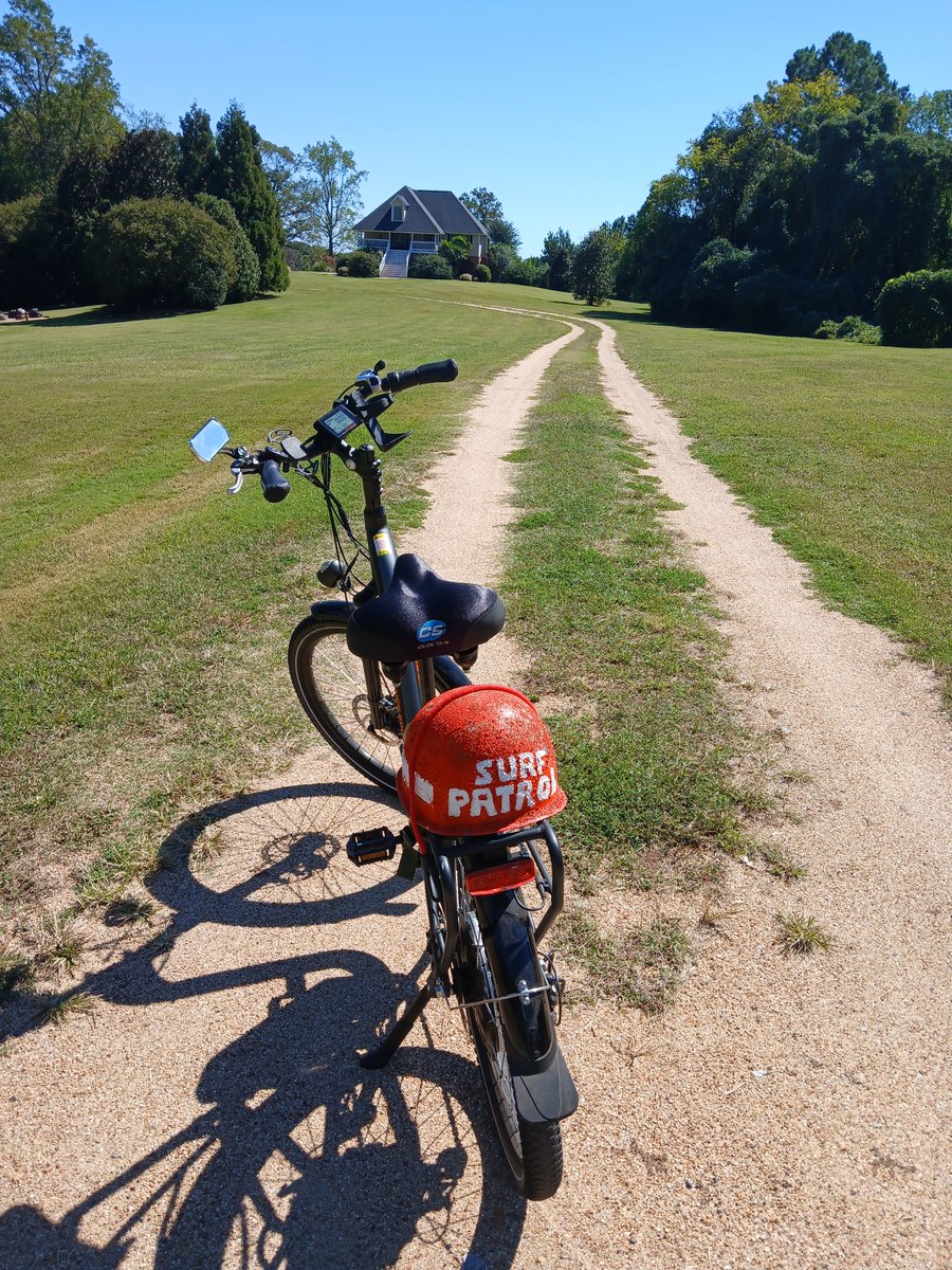 TimBnSC's tweet photo. That's  Pineapple Hill, my "beach house in a cow pasture" in rural South  Carolina, in the background. I ride my bike on country roads. The bright  helmet lettered "Surf Patrol" prompts logging trucks to slow down as  they approach, avoid squishing me like a bug. https://t.co/DRsSbmhmSs