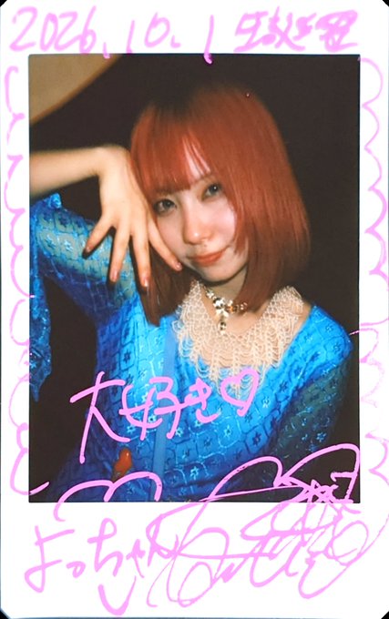 A signed polaroid photo dated '2026.10.1' features a person with a short red bob wearing a blue lace top, with pink handwriting and signatures across the white border.