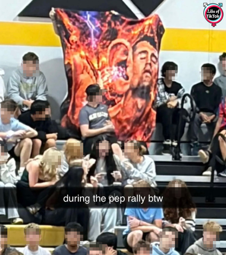 libsoftiktok's tweet photo. INBOX: Students at a homecoming pep rally at Blue Valley High School (@bvschools) in KS were spotted holding what appears to be a large meme banner MOCKING Charlie Kirk.

How was this allowed? https://t.co/NgMsZ1oIFW