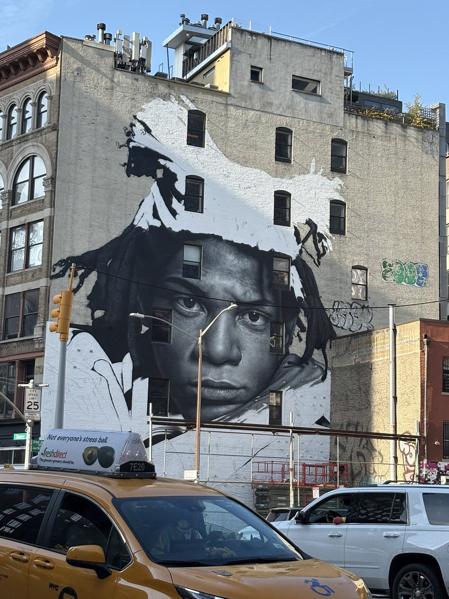 evgrieve's tweet photo. WIP look at the 6-story-tall mural of Jean-Michel Basquiat taking shape on the SW corner of the Bowery at Great Jones. The work is by New Zealand-based street artist Owen Dippie. Basquiat lived two buildings west at 57 Great Jones St. when he died in 1988. https://t.co/pj4AEbFxoB