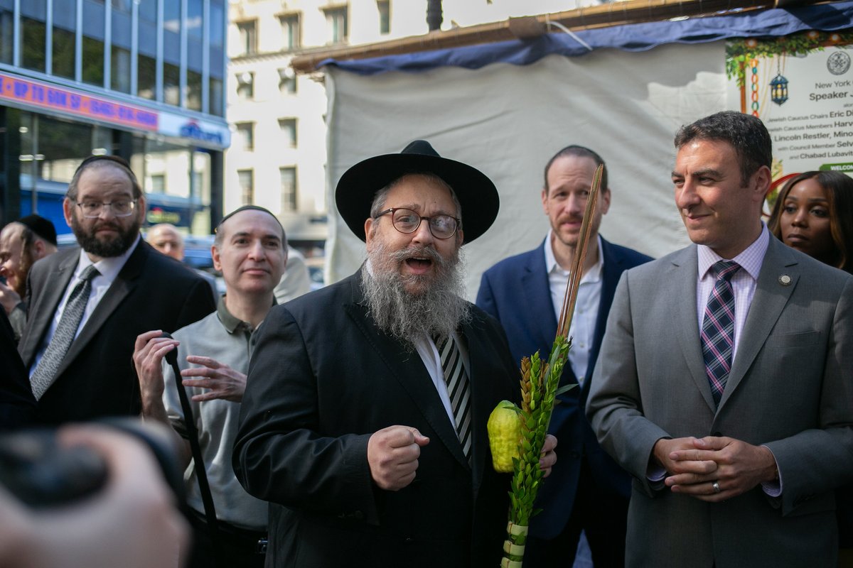 NYCCouncil's tweet photo. The Council hosted Sukkot at City Hall this week with our very own Sukkah.

Council Members joined New Yorkers in holding the etrog (citron fruit) and shaking the lulav (palm frond) in every direction, representing the unity of the Jewish people with the four species.

Chag Sukkot Sameach to all who celebrate!