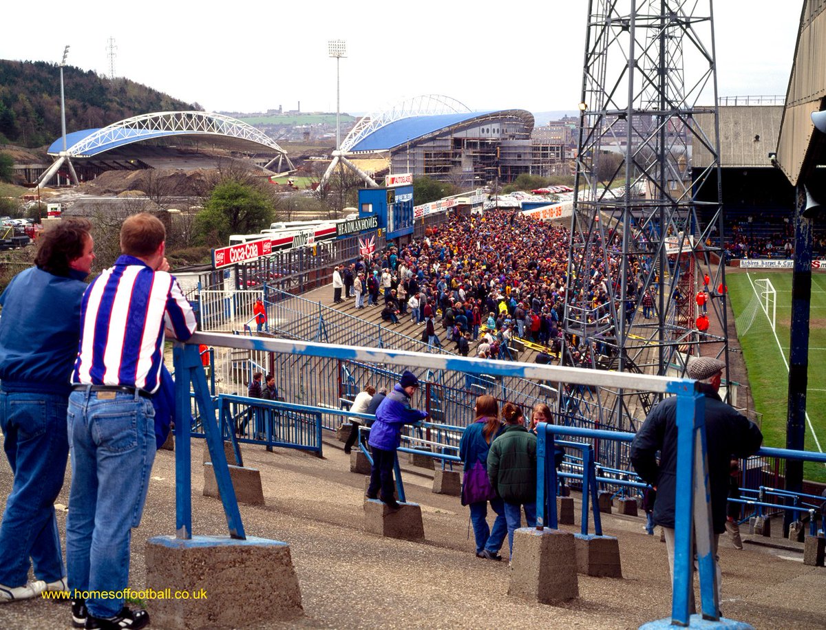 HOMESofFOOTBALL's tweet photo. The beauty & value of British football as we have known it, down thru the years growing up.

1994 was important. The World Cup 'in America' might change some things. 

Meanwhile the auld Brit clubs were rebuilding...
"NEW HOME ON THE HORIZON" Huddersfield Town v Bradford City year1994 Photo©stuartroyclarke/homesoffootball #htafc