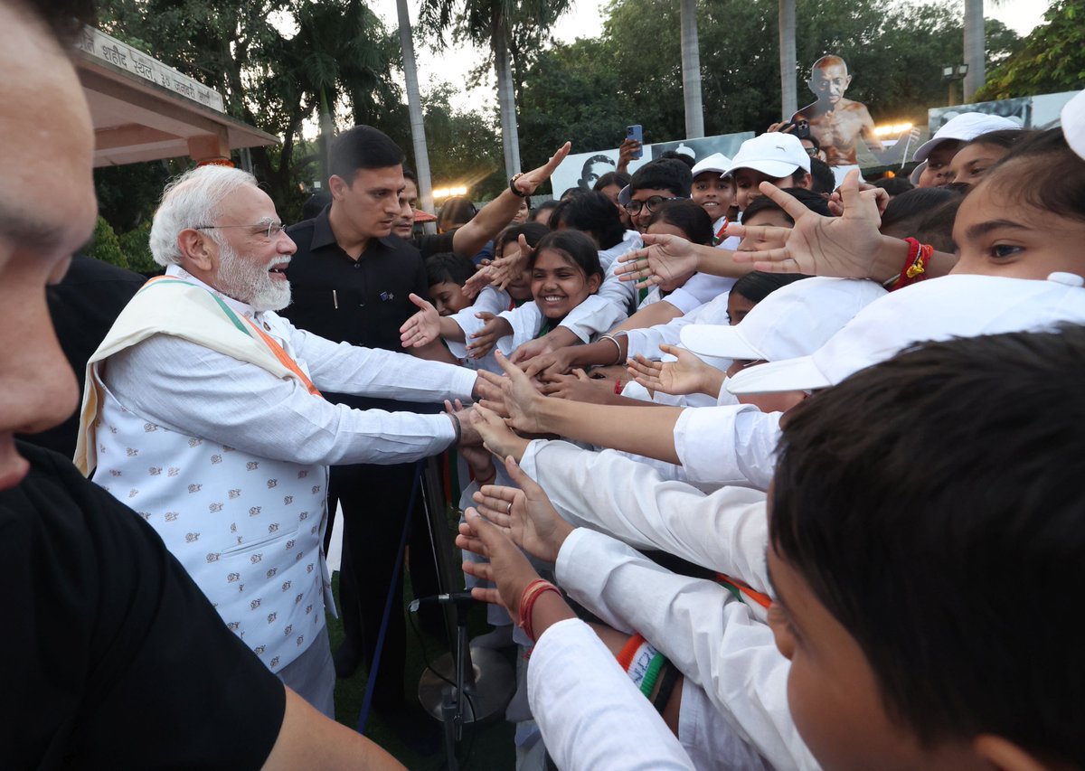 ANI's tweet photo. Delhi: Prime Minister Narendra Modi greeted students present at Gandhi Smriti after attending a prayer meeting there on the occasion of Gandhi Jayanti. https://t.co/Q50iM7KUIR