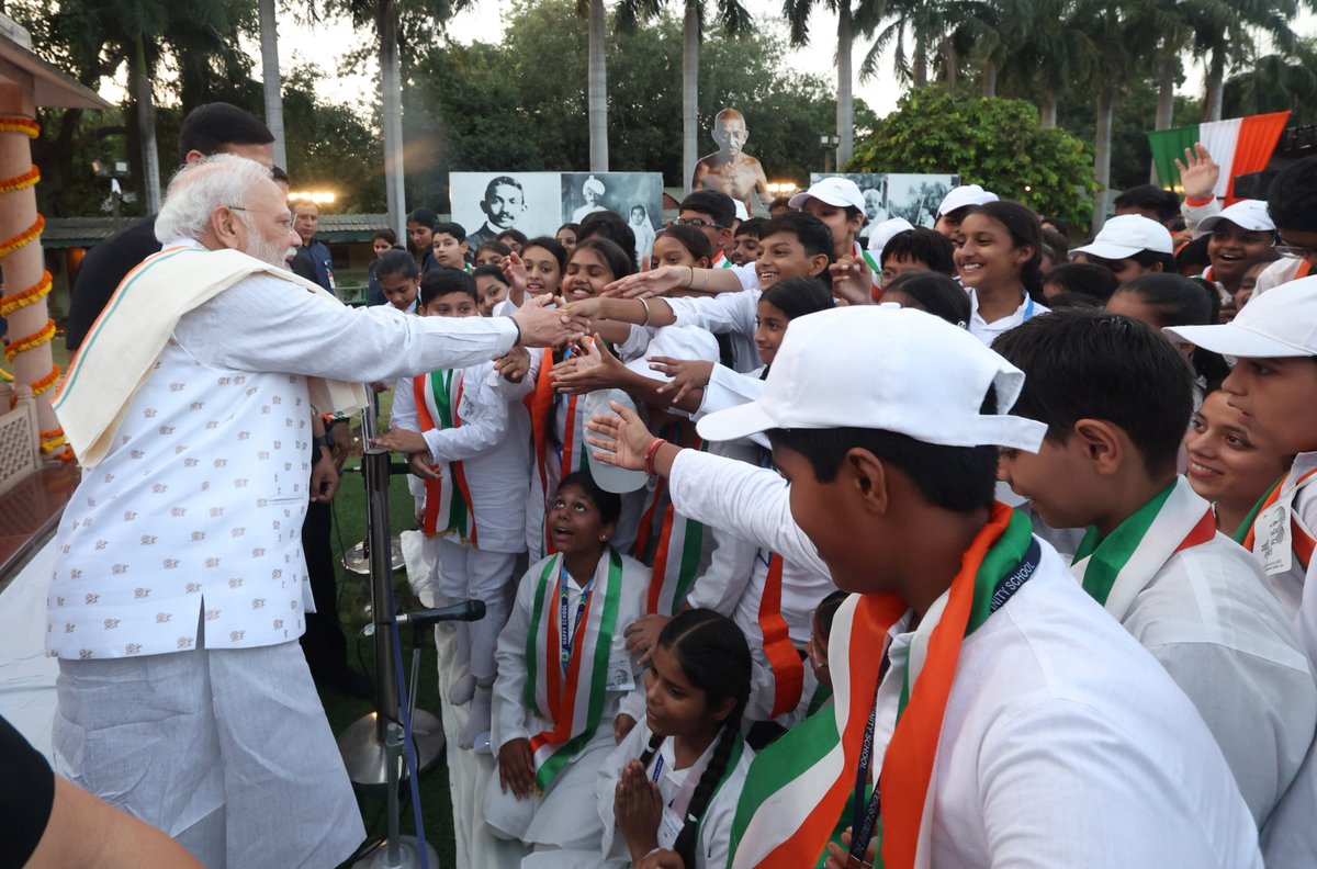 ANI's tweet photo. Delhi: Prime Minister Narendra Modi greeted students present at Gandhi Smriti after attending a prayer meeting there on the occasion of Gandhi Jayanti. https://t.co/Q50iM7KUIR