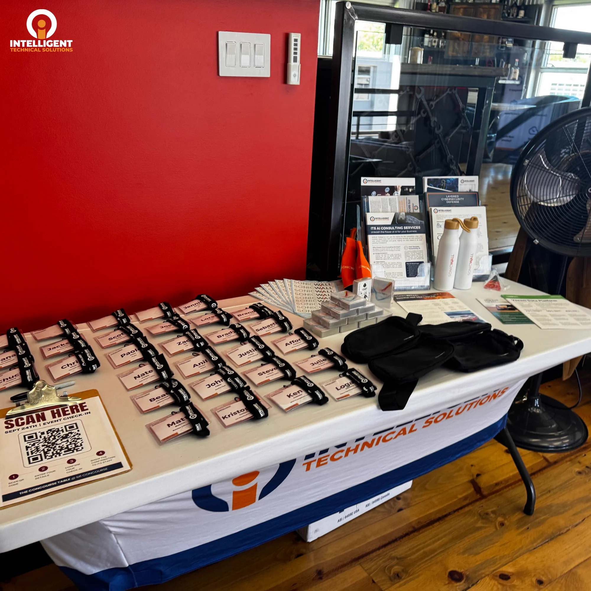 ITS event table displays attendee materials, cybersecurity resources, and partner giveaways at Full Throttle.
