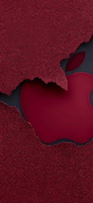 A dark red Apple logo is revealed against a black background, with the surrounding paper-like texture torn away in jagged edges.
