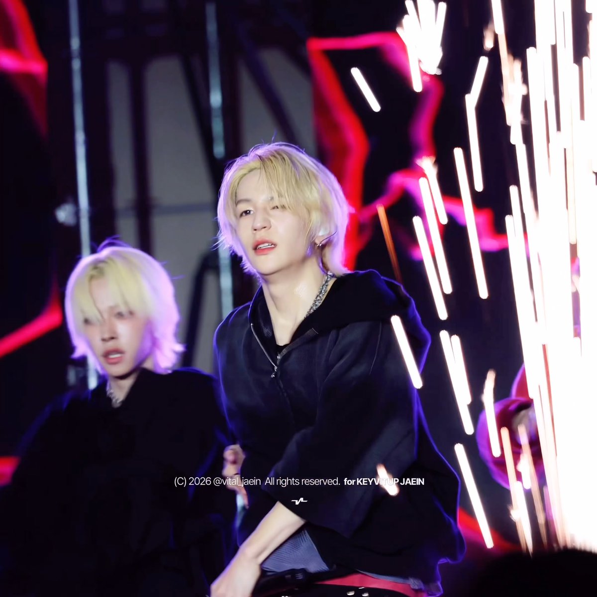 Two performers with blonde hair in dark hoodies perform on stage with sparks flying around them, with a watermark reading '(C) 2026 @vital_jaein All rights reserved. for KEYVITRIP_JAEIN'.