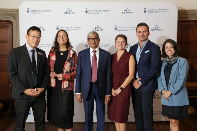 Six people stand in a row in front of a backdrop with University of Toronto Faculty of Applied Science & Engineering and Defy Gravity logos at Hart House. Left to right: Chris Yip, Isi Caulder, Praveen Jain, Magdalena M. Krol, Tony Pialis and Ines Fernandez.