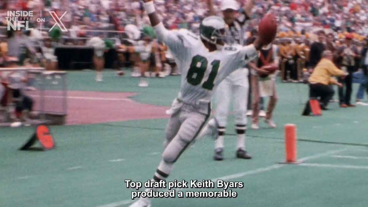 Philadelphia Eagles player #81, identified by on-screen text as top draft pick Keith Byars, celebrates with arms raised in the end zone after scoring a memorable touchdown, likely the halfback pass referenced in the accompanying post from the Eagles' 1986 victory over the Rams.