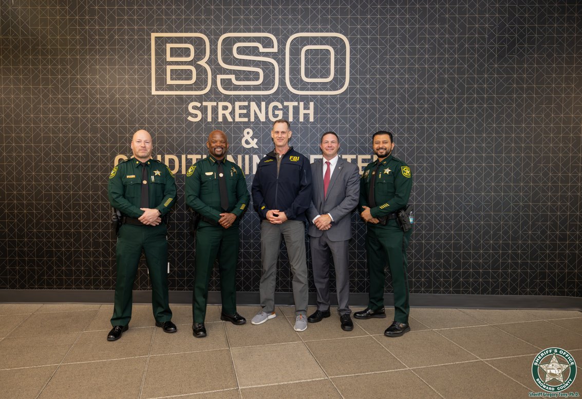 FBIMiamiFL's tweet photo. Strong partnerships make our communities safer. On Thursday, October 1, Special Agent in Charge Brett Skiles and Assistant Special Agent in Charge Christopher Caldwell met with Broward Sheriff Dr. Gregory Tony at the Research, Development and Training Center to strengthen our partnership and discuss the importance of fitness and wellness for law enforcement professionals. It was an honor to visit the center and reaffirm our shared commitment to collaboration, training, and service.