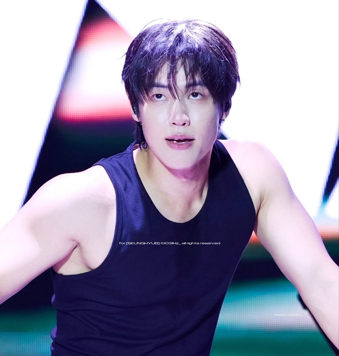 A male K-pop performer with dark sweaty hair wearing a black tank top is captured mid-performance; the image is watermarked 'for [SEUNGHYUB] @103Hz_all rights reserved' and 'PADO @103Hz'.