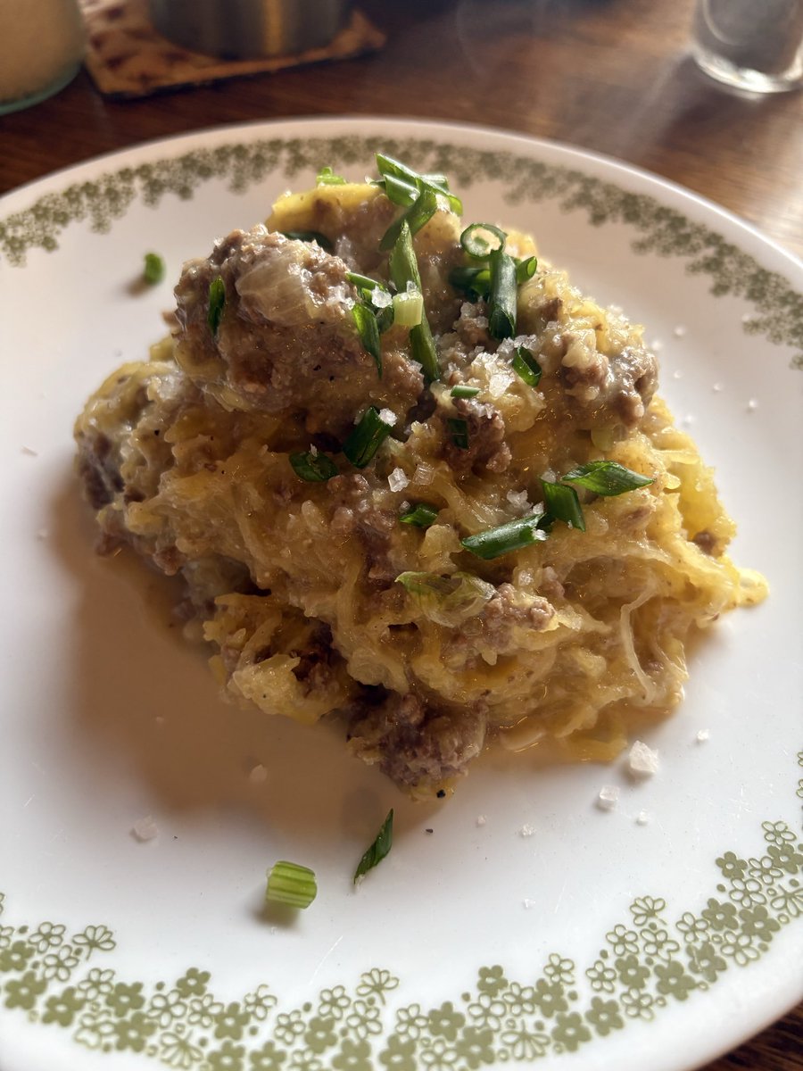 MrsKristinaCook's tweet photo. Since I’m re-reading Dr. Salisbury’s 1888 book “The Relation of Alimentation and Disease” I was inspired to come up with a Salisbury Steak Spaghetti Squash for dinner. 

His original Salisbury steak was made with lean beef, minced, formed into a patty, fried and served with butter, salt, and pepper. This is how he approached every symptom, every ailment, and every disease all over and throughout the human body. 

Our Standard Western Diet turned around and put a gravy with it, added mushrooms, onions, and thickened it with flour then served it up beside a mountain of potatoes and maybe some side vegetables. None of those things are foods that Salisbury included in his elimination protocol. In fact, once the symptoms on his all meat, broth/stock diet had alleviated, he would reintroduce carbohydrates one bite of bread at a time until the symptoms began to reoccur and then he’d have you go back to his original plan and start over. This is what we now call “finding your carbohydrate tolerance.”

This spaghetti squash dish took a little bit of both worlds and put them together. Ground beef, low carb squash, and a gravy made out of softened and caramelized onions cooked in butter, with garlic, beef stock, and goat cheese added at the end and puréed into a beautiful gravy. 

Even my picky onion hater loved this! Apparently, the secret is puréeing all the things she doesn’t like into a creamy sauce. 😉
