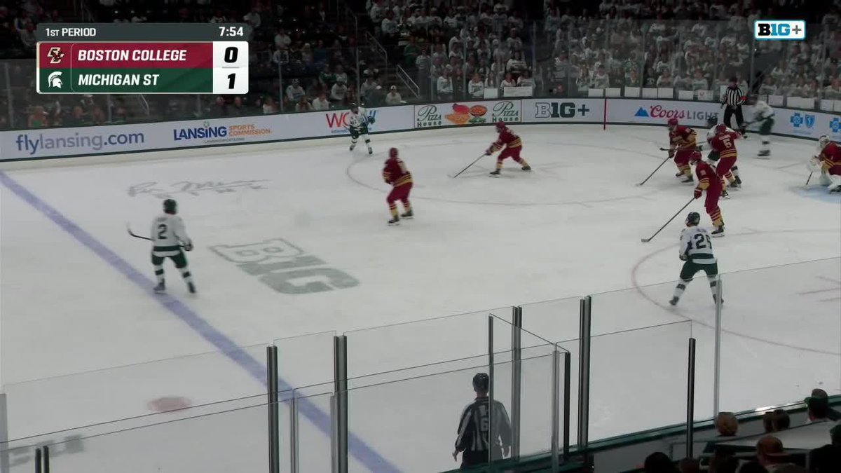 A hockey game broadcast shows Michigan State leading Boston College 1-0 with 7:54 remaining in the 1st period, capturing the moment just before Eric Nilson's snipe extends the lead to 2-0.