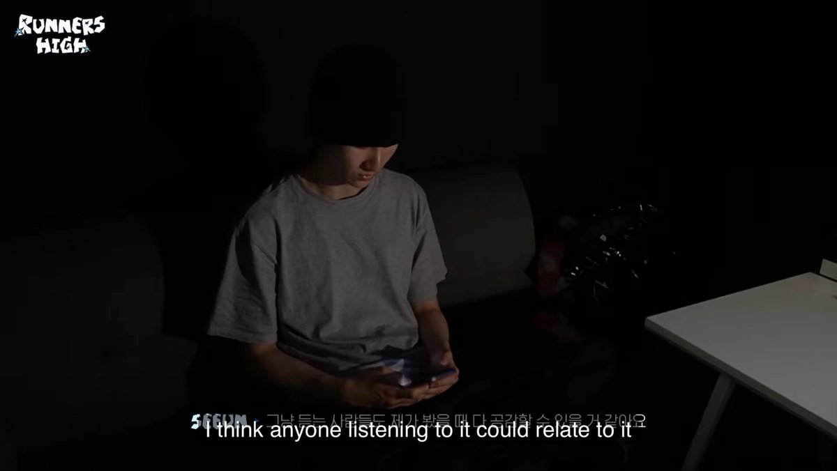 A still from what appears to be a video on SE SOON's "Runners High" page showing a person wearing a beanie looking down at a phone in a dark room, with subtitles reading "I think anyone listening to it could relate to it."