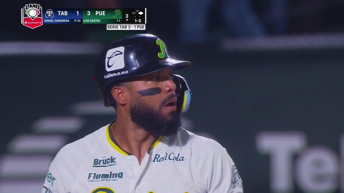 A baseball player with eye black and a beard wearing a helmet with a "P" logo; the scoreboard shows TAB 1, PUE 3, with Daniel Camarena pitching and Luis Castro batting, in Serie TAB 3-1 PUE.