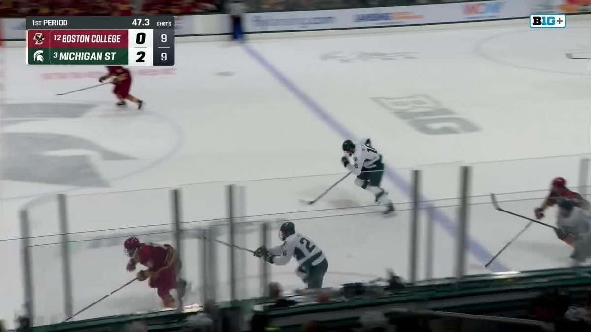 Michigan State's #71 makes a crucial defensive play against a Boston College 2-on-1 rush, with the scoreboard showing 47.3 seconds remaining in the 1st period and Michigan State leading 2-0 (shots tied 9-9) in this Big Ten matchup.