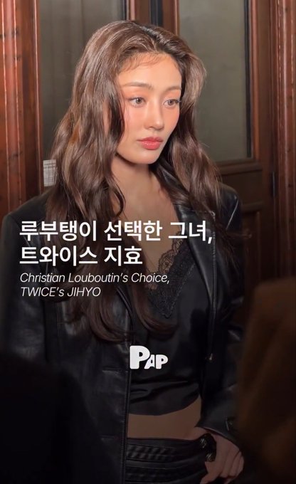 A woman with long brown hair wearing a black satin top and lace details, with Korean text and 'Christian Louboutin's Choice, TWICE's JIHYO' caption, and 'PAP' logo.