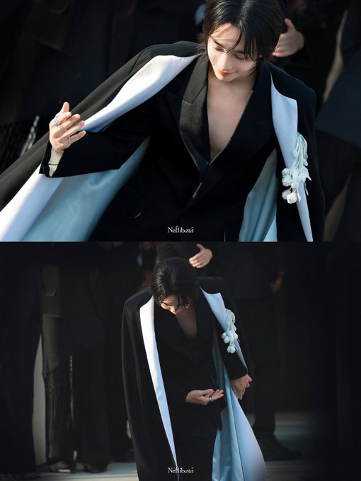 Two photos of a performer in a sharp black blazer featuring a light blue lining and a decorative white embellishment on the sleeve.