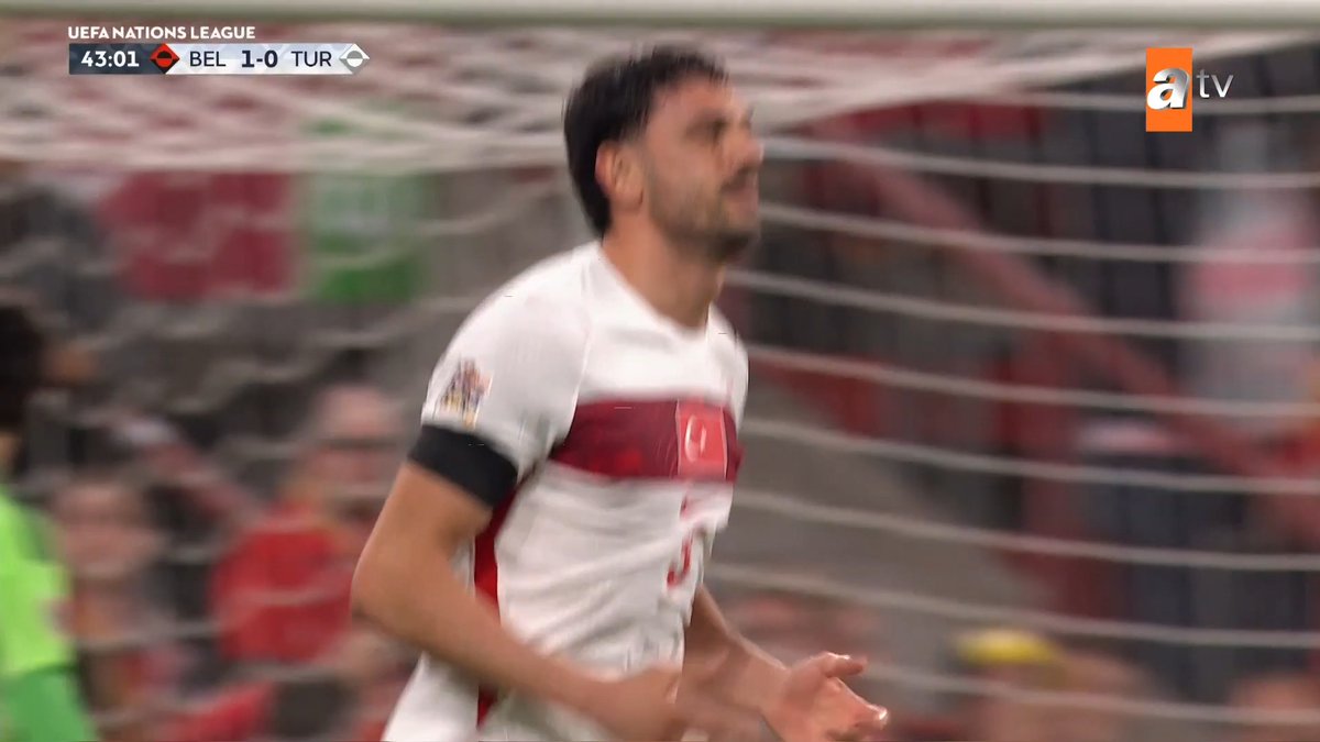 Turkey's Merih Demiral reacts in frustration after missing an open goal opportunity during the UEFA Nations League match against Belgium, with the scoreboard showing Belgium leading 1-0 at the 43:01 mark.