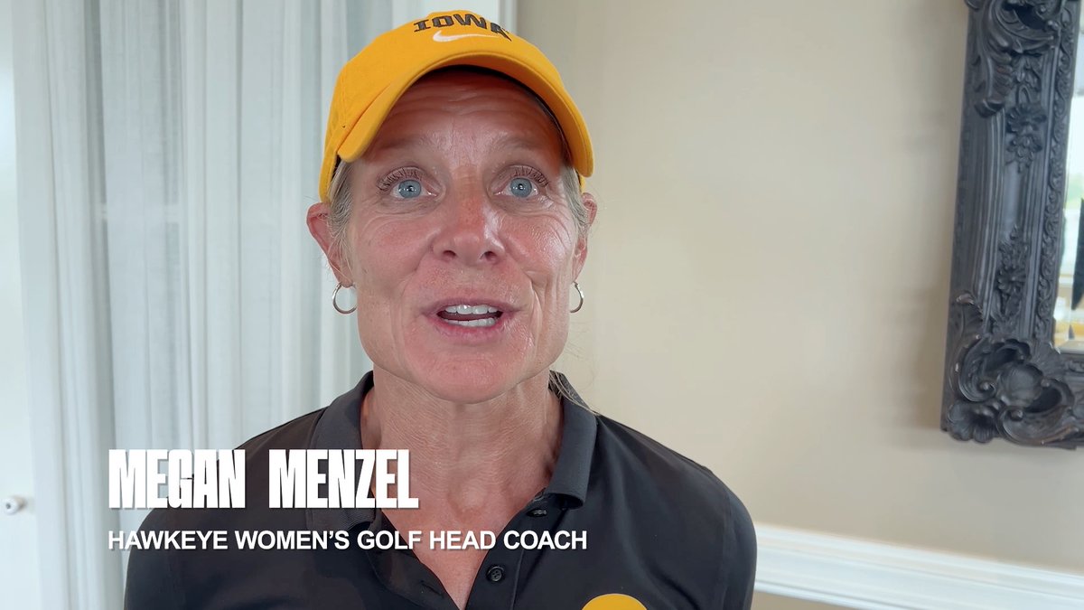 A woman wearing a yellow 'IOWA' cap speaks to the camera, with text overlay reading 'MEGAN MENZEL HAWKEYE WOMEN'S GOLF HEAD COACH'.