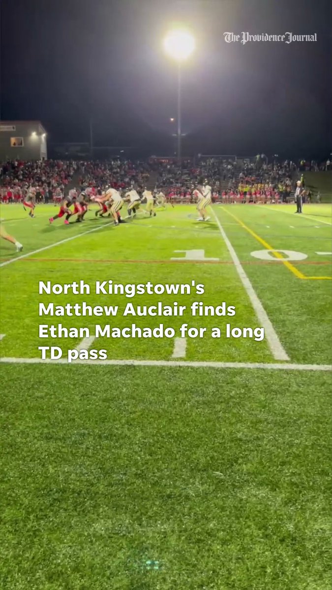 A nighttime high school football game where text reads 'North Kingstown's Matthew Auclair finds Ethan Machado for a long TD pass,' credited to The Providence Journal.