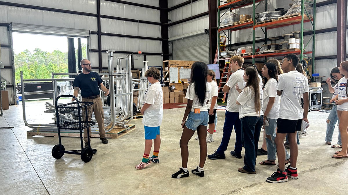 NettingPros's tweet photo. The next generation of the @NassauFL workforce spent #MFGDay26 with us. Yulee High School students toured our facility to see how we design, engineer, fabricate and install for sports facilities across the U.S. Thanks for visiting, students! @NassauFL @MfgDay https://t.co/DGymEP8NY6