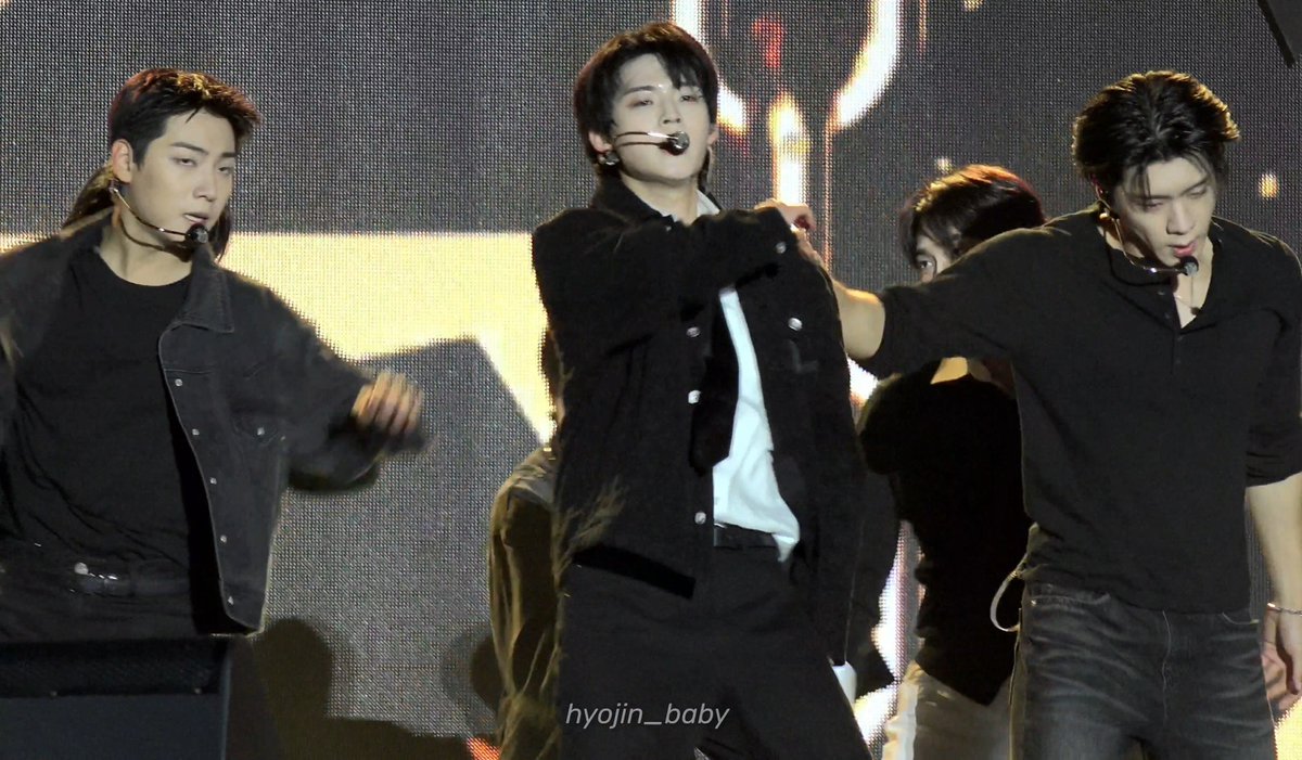 Three members of Stray Kids (Seungmin, I.N, and Hyunjin) perform energetically on stage, wearing coordinated black outfits and headset microphones, with the watermark "hyojin__baby" visible.