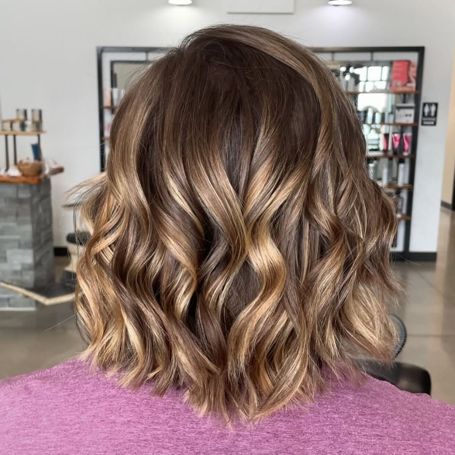 CMHNM's tweet photo. Dawna is bringing the caramel glow with this balayage. Shoulder-length brunette hair with caramel highlights styled in curls. https://t.co/GPT5wC08ll