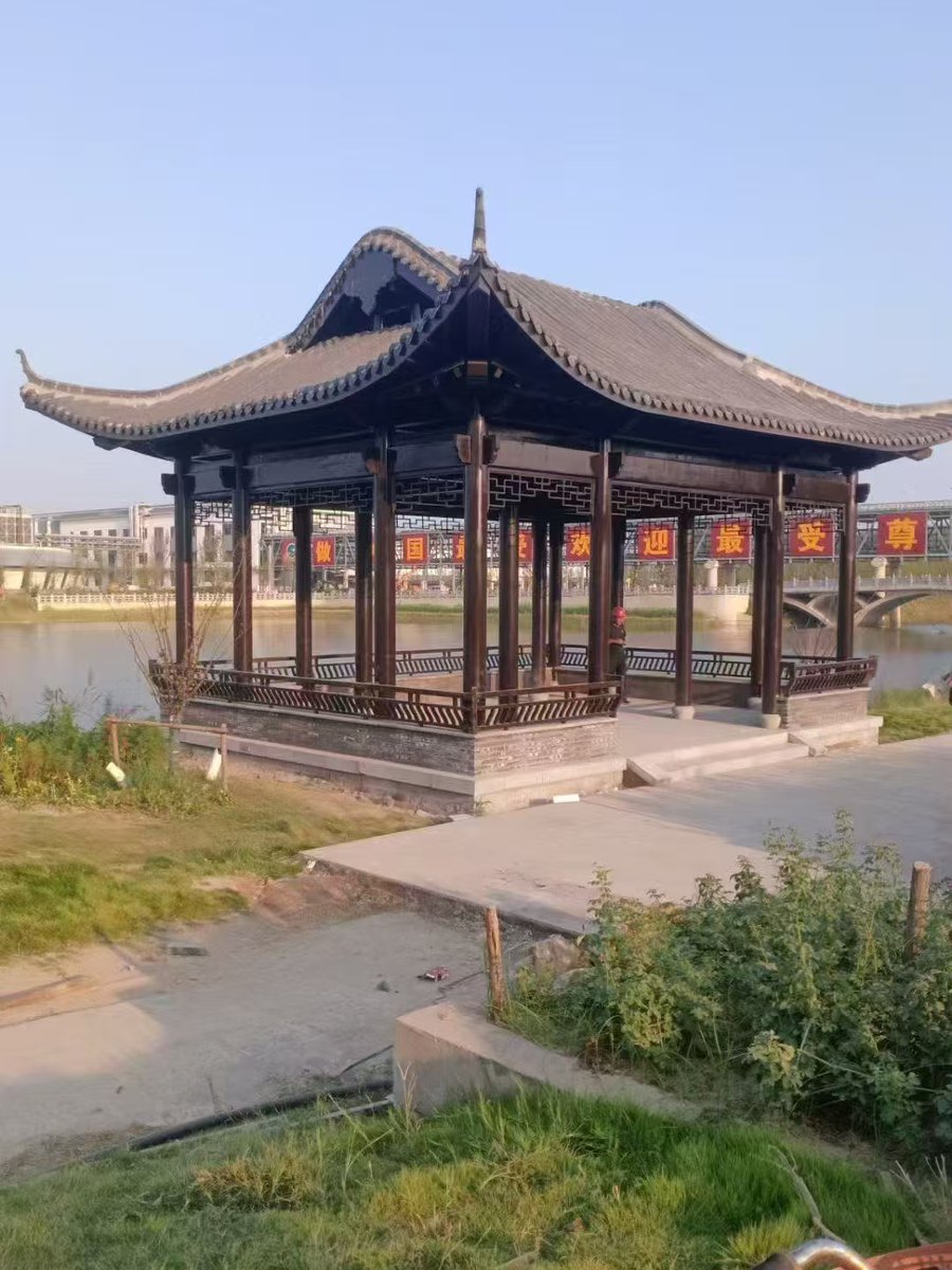 W8YCxFtYRi1BJPd's tweet photo. In a traditional Chinese village, an old pavilion with intricate carvings stands by the river, a time-honored legacy carrying generations of memories—let’s cherish our precious cultural heritage. https://t.co/p9b2FdExt0