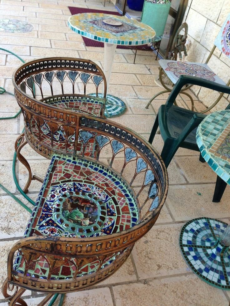 TacitusChrono's tweet photo. I’ve never seen a bench quite like this. The curved iron, colorful mosaic, and that tiny figurative detail make it feel like a piece of art you can actually sit on. https://t.co/pvKzoFKgLm