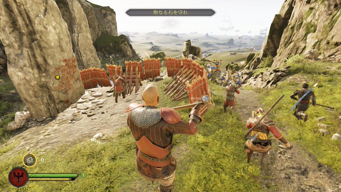 A third-person video game screenshot showing a medieval warrior in chainmail defending a barricade with spears, with Japanese text reading '聖なる丘を守れ' (Defend the Sacred Hill) displayed at the top.